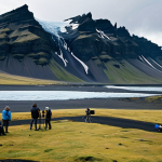 **

A scenic view of Iceland's dramatic landscape, featuring mountains and glaciers, with a film crew discreetly positioned in the foreground, shooting a scene. Fully clothed actors in modest, practical clothing are visible but not the focus. The scene should evoke a sense of cinematic grandeur and the power of nature. Safe for work, appropriate content, fully clothed, professional, landscape photography, high quality.

**